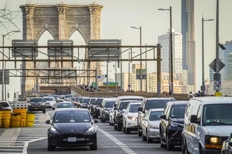 FILE - Traffic enters lower Manhattan after crossing the Brooklyn Bridge, Thursday, Feb. 8, 2024, in New York. New York Gov. Kathy Hochul on Wednesday, June 5, 2024 indefinitely delayed implementation of a plan to charge motorists big tolls to enter the core of Manhattan, just weeks before the nation's first “congestion pricing” system was set to launch. (AP Photo/Bebeto Matthews, File)