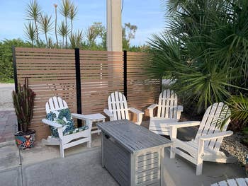 Outdoor patio with four Adirondack chairs and a coffee table, suitable for a garden setup
