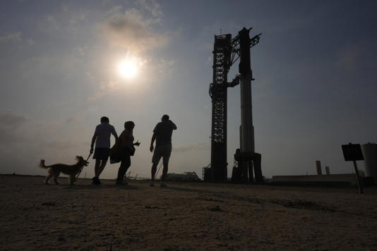 Onlookers watch as SpaceX's mega rocket Starship is prepared for a test flight from Starbase in Boca Chica, Texas, Wednesday, June 5, 2024. (AP Photo/Eric Gay)