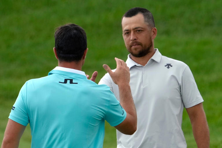 Jun 6, 2024; Dublin, Ohio, USA; Xander Schauffele (first) and Viktor Hovland shake hands on the 18th green during the first round of the Memorial Tournament at Muirfield Village Golf Club. Mandatory Credit: Barbara J. Perenic-USA TODAY Sports