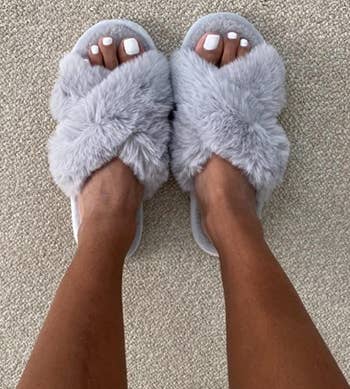 reviewer wearing the gray fuzzy slippers