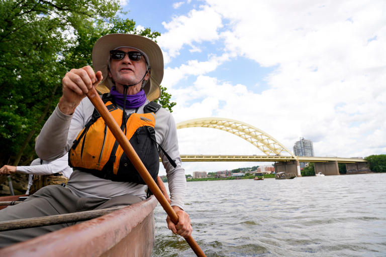 John Nation helps paddle the canoe during the Ohio River Way Challenge, Thursday, June 6, 2024, on the Ohio River in Cincinnati. A team of people on canoes are making a 250-mile trip down the Ohio River that started in Portsmouth and ending in Louisville. The purpose of the trip is to promote the beauty of river towns and appreciate the natural landmark that is the Ohio River.