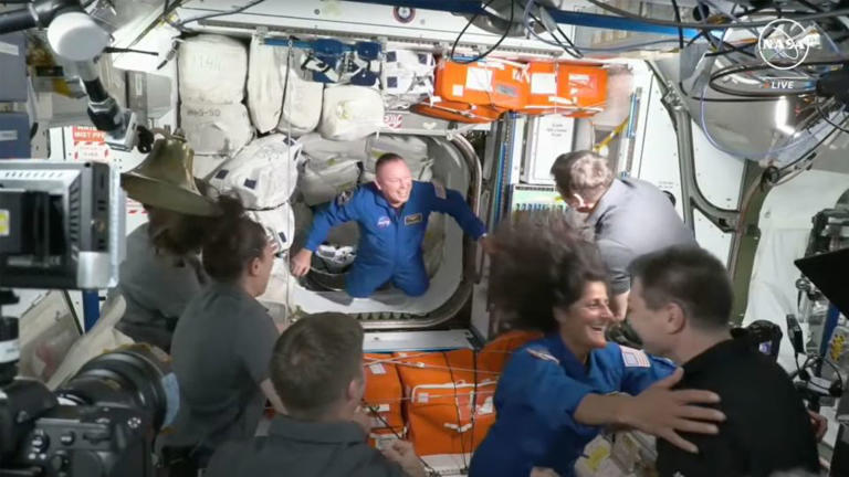 Butch Wilmore (left) and Suni Williams enter the space station from Starliner. - NASA