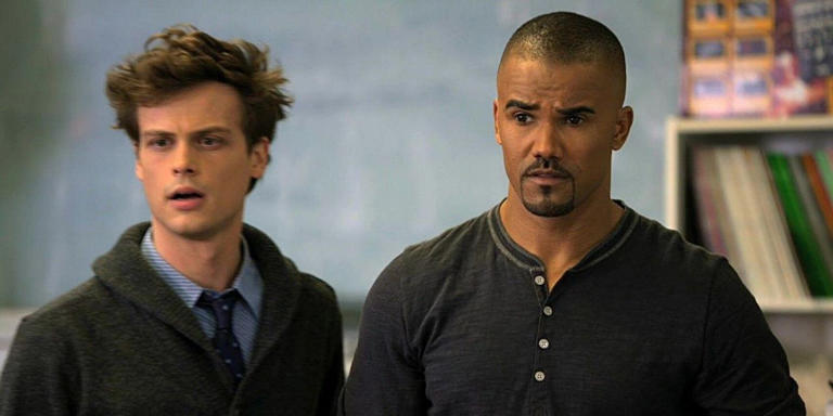 Reid and Morgan look at something offscreen with shock on their faces in Criminal Minds