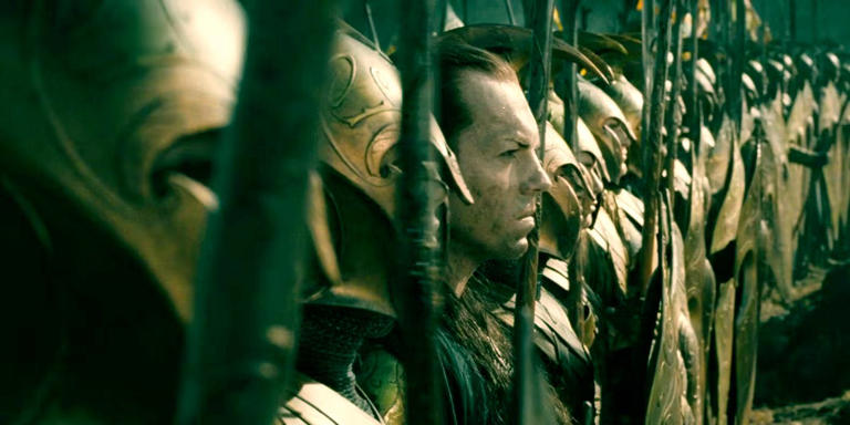 Elrond (Hugo Weaving) stands surrounded by Elves in LOTR's The Last Alliance.