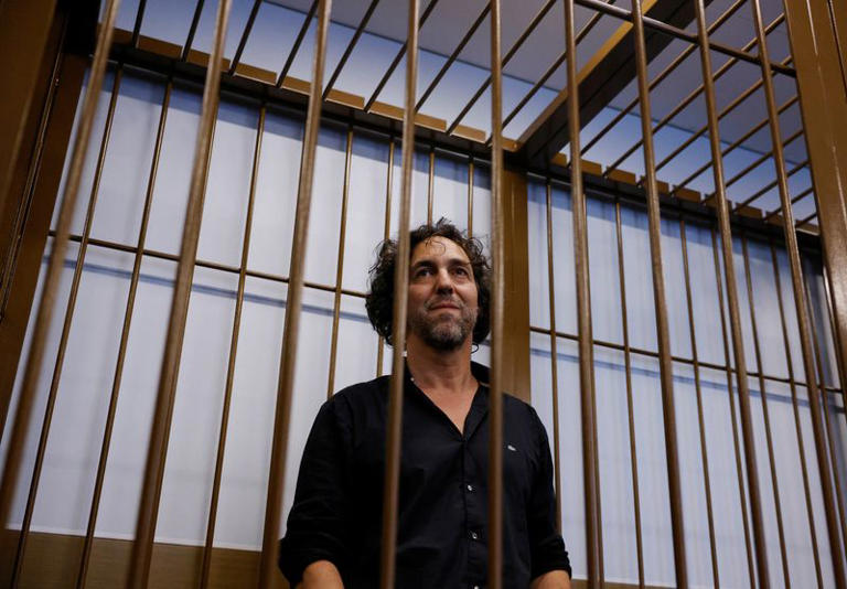 French national Laurent Vinatier, an adviser to the Swiss nonprofit Centre for Humanitarian Dialogue, who was detained on suspicion of gathering information on Russia's military activities, stands inside an enclosure for defendants before a court hearing in Moscow, Russia June 7, 2024. REUTERS/Maxim Shemetov
