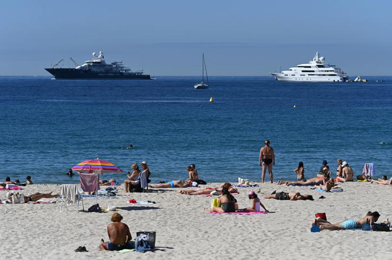Tourists on the beach in Cannes, France, as the Foreign Office issued a new warning alerting people to travel disruption at ports and airports