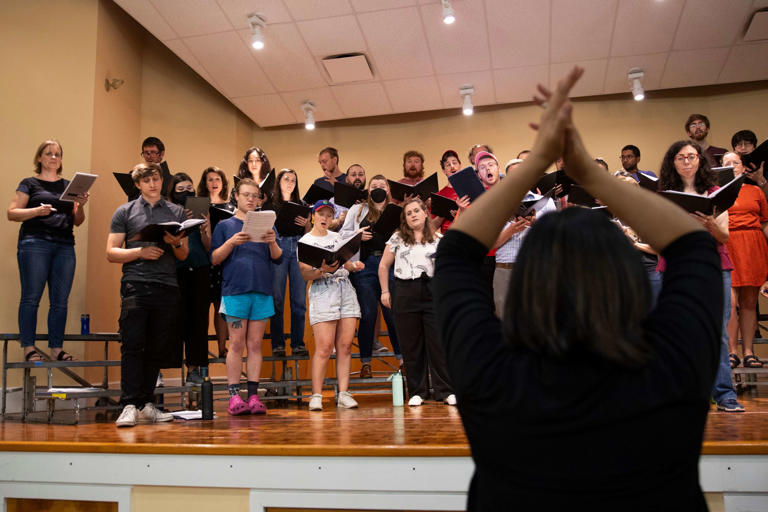 Artistic Director Mitos Andaya Hart directs the PhilHarmonia rehearsal for their 10th anniversary concert at Settlement Music School's Germantown branch this week.