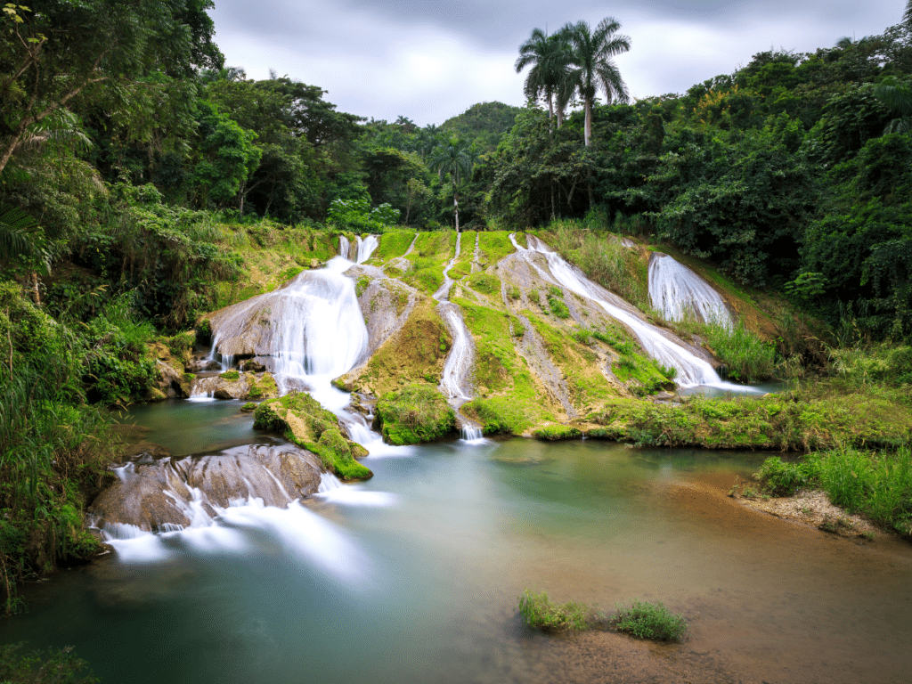 <p>Cuba is filled with fantastic places to get off the beaten path and hike through the stunning interior of the country. One of the best spots to explore on foot is the stunning Topes de Collantes area in the Escambray mountains <a href="https://hometohavana.com/blog/day-trips-from-trinidad-cuba">just west of Trinidad</a>. Home to countless waterfall hikes like El Nicho, Salto de Caburní, and Vegas Grande, this is a great place to escape for a day trip to an impressive natural spot.</p>