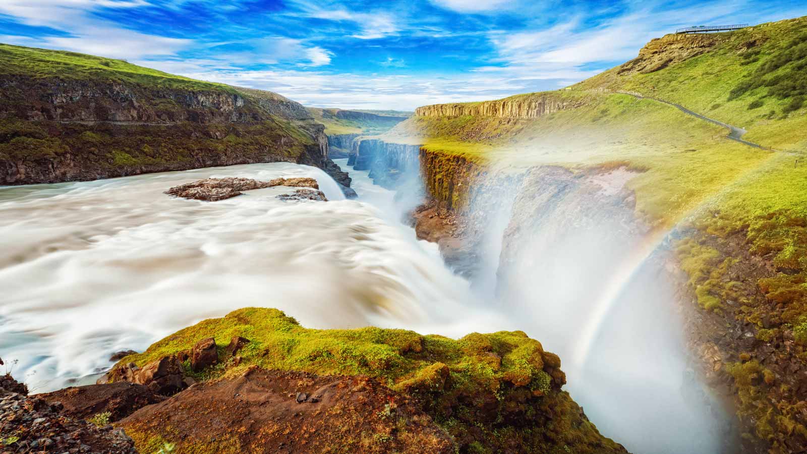 <p><span>Gullfoss, meaning “golden falls,” is located on Iceland’s Hvita River. The waterfall’s name comes from the glacial sediment that makes the water glow gold in the sunlight. </span></p><p><span>The 105-foot-tall falls cascade in two stages at nearly right angles, creating an illusion that the golden waters stretch to the ends of the Earth. Gullfoss is a truly magical sight against Iceland’s lush, green landscape.</span></p>