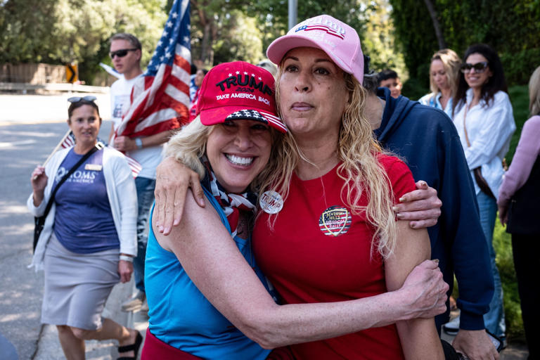 Trump supporters Lisa Allyn, left, and Shiva Bagheri wait along Sunset Blvd. hoping to get a glimpse of Donald Trump as he heads to a fundraiser on Friday, June 7, 2024.
