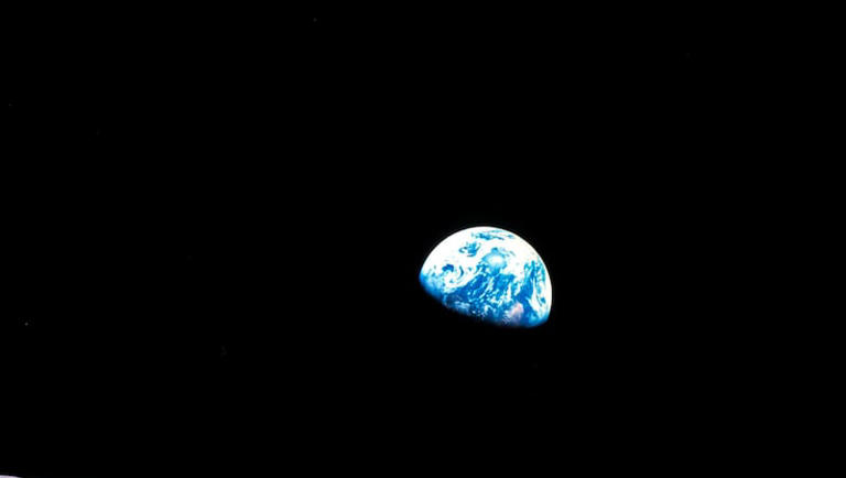 This Dec. 24, 1968, file photo made available by NASA shows the Earth behind the surface of the moon during the Apollo 8 mission.