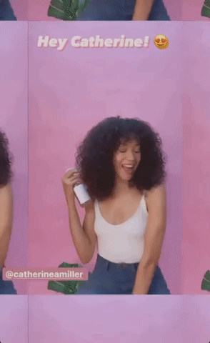 Model spraying their curly hair