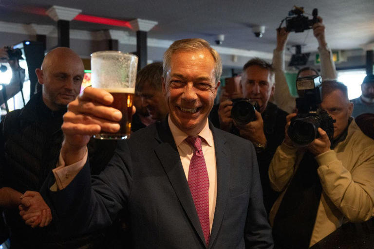 Reform UK party leader Nigel Farage drinks a pint of beer before speaking to supporters as he launches his election candidacy at Clacton Pier on June 4, 2024, in Clacton-on-Sea, England. Getty Images