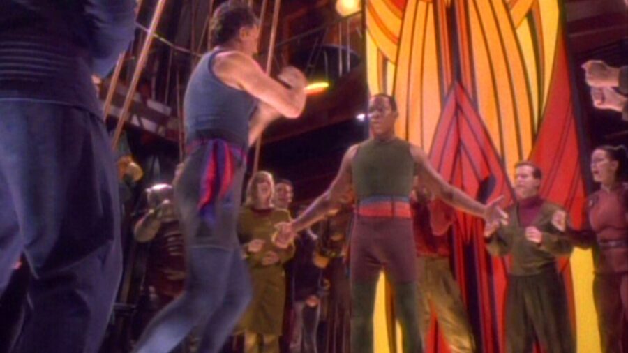 <p>The Star Trek outtake in question is based on that scene, showcasing the moment that led up to the boxing match. In the finished episode, Sisko demands that Q return the various station personnel that he just snapped out of existence. When Sisko barks, “bring them back, Q,” the godlike being responds with, “or what, you’ll thrash me,” leading to their infamous boxing match.</p>