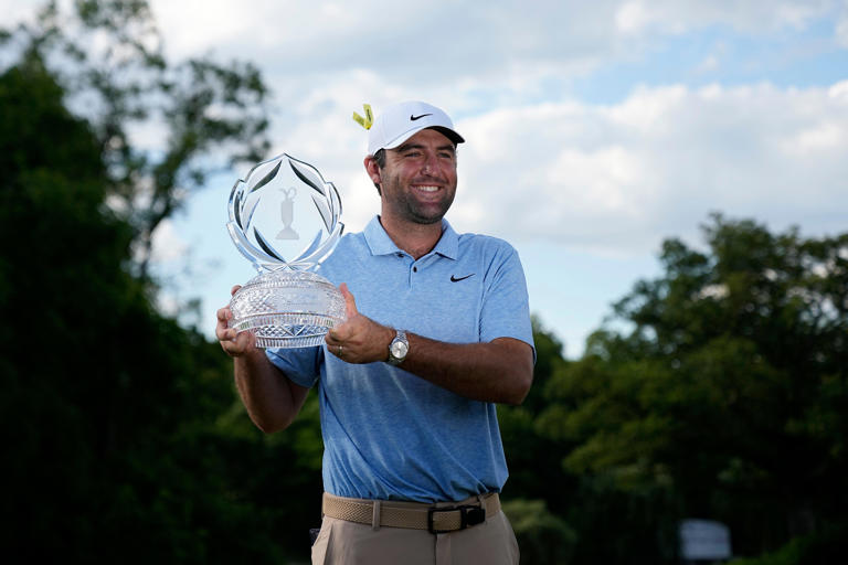 Scottie Scheffler poses with the trophy after winning the Memorial at Muirfield Village Golf Club on Sunday.