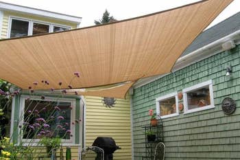 Canopy in corner of backyard between the house