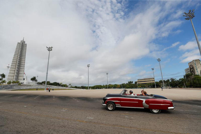 Tourists ride in a vintage car at the Revolution Square in Havana, Cuba, June 8, 2024. REUTERS/Yander Zamora