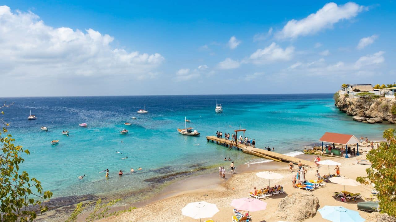 <p>Curaçao has several incredible white-sand beaches worth exploring, but a favorite hidden gem is Playa Lagun on the island’s southwest shore. Playa Lagun stands out for its unique, protected bay, laid-back atmosphere, and incredible snorkeling (and cliff diving!) potential. Dramatic cliffs protect this small cove beach from waves, making it the perfect beach spot for families looking for little to no waves for beginner swimmers.</p>