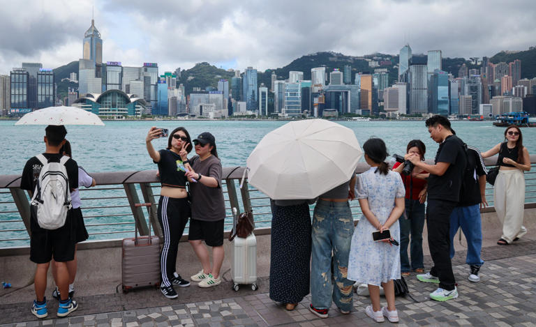 Tourists take selfies on the Tsim Sha Tsui waterfront over the Dragon Boat Festival long weekend. Photo: Jelly Tse