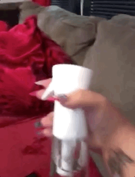 a gif of a reviewer using the spray bottle