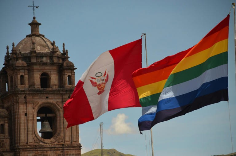 The capital of Peru with national flags and pride flag next to it.