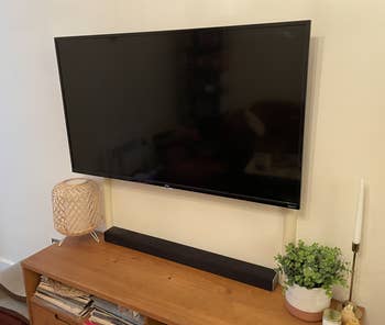A BuzzFeeder's TV with the beige cord cover