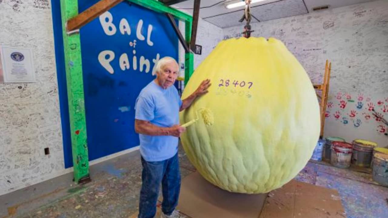 <p>Wait to drive through Indiana before stopping by this infamous attraction. The Biggest Ball of Paint started as a baseball. <a href="https://www.roadsideamerica.com/story/9792" rel="noopener">Michael Carmichael</a>, the man behind the ball, got his young son to paint over it, and now it weighs over 2.5 tons. </p><p>At first, Michael intended to cut the ball in half to see what the inside looked like, but now that it’s become such a famous landmark, he leaves it for travelers and visitors. </p>