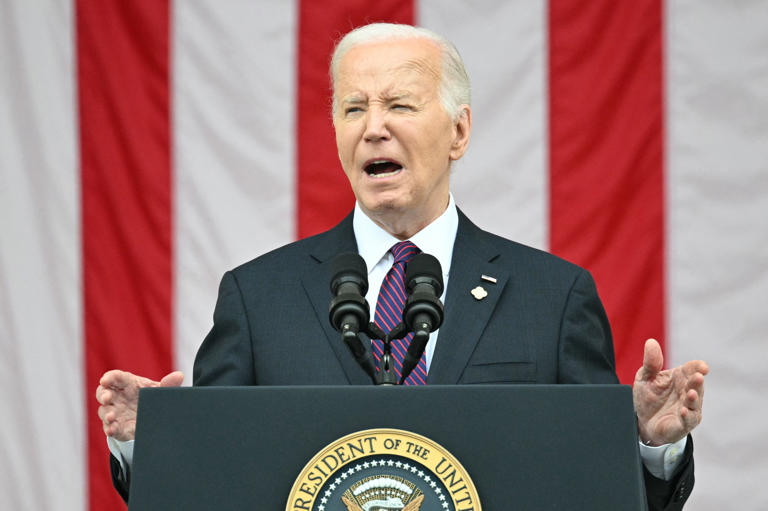 US President Joe Biden speaks at the 156th National Memorial Day observance at Arlington National Cemetery in Arlington, Virginia, May 27, 2024. Conservative commentators on X shared video which they claimed showed Biden falling asleep at the event.