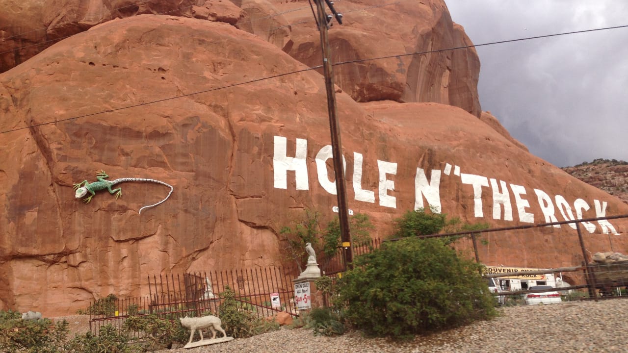 <p>Remember to stop at this infamous attraction when driving along U.S. Highway 191 in Utah. The Hole n” the Rock is <a href="https://www.theholeintherock.com/#moreingo" rel="noopener">located in San Juan County</a> and features a home carved out of a large cliff. Albert Christensen began building the home in 1940 for his family, who moved into it in 1952.  </p><p>When he passed in 1957, the home was opened for public tours. The unusual home features 14 rooms, a deep bathtub, furniture, and tools used to build the house, making it an <a href="https://wealthofgeeks.com/every-states-most-iconic-landmark/" rel="noopener">iconic landmark</a> that travelers across the globe flock to see.</p>