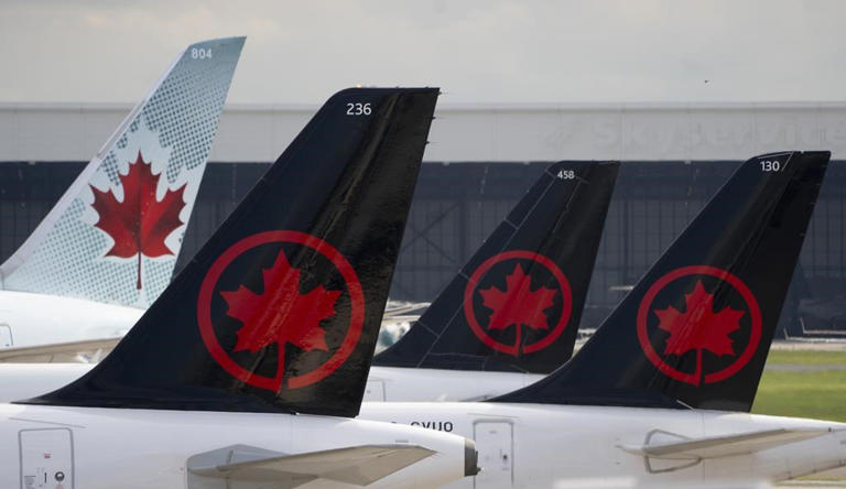 Air Canada logos are seen on the tails of planes at the airport in Montreal, Monday, June 26, 2023. THE CANADIAN PRESS/Adrian Wyld