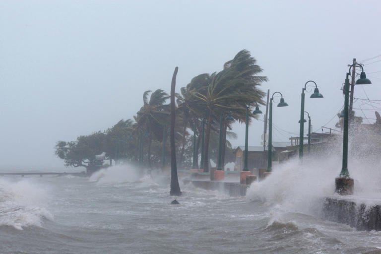 Waves crash against a seawall as Hurricane Irma slammed across islands in the northern Caribbean in 2017, in Fajardo, Puerto Rico [File: Alvin Baez/Reuters]