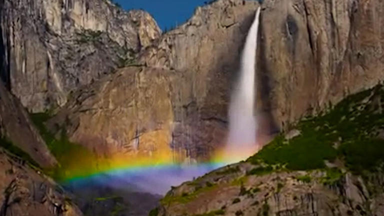 A lunar rainbow reflects off a waterfall at Yosemite, a national park in California.