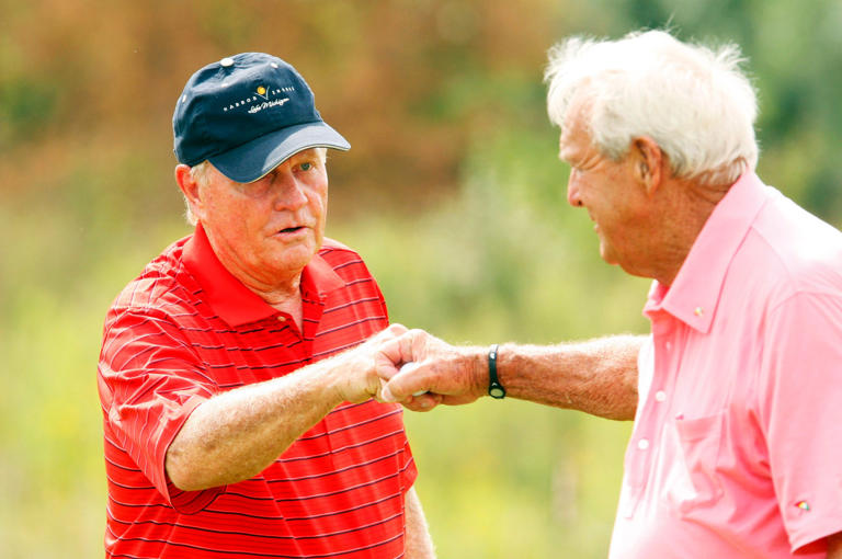 5/23/2012: Jack Nicholas offers a fist bump to Arnold Palmer after Palmer birdied hole #4 at the Golf Club at Harbor Shores in Benton Harbor Tuesday, August 10, 2010.