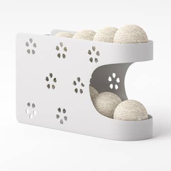 White double-decker storage organizer holding dryer balls