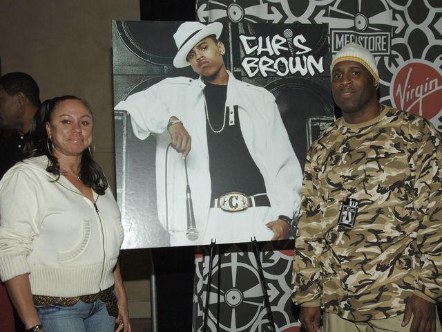 L. Busacca/WireImage Joyce Hawkins and Clinton Brown with poster of Chris Brown.