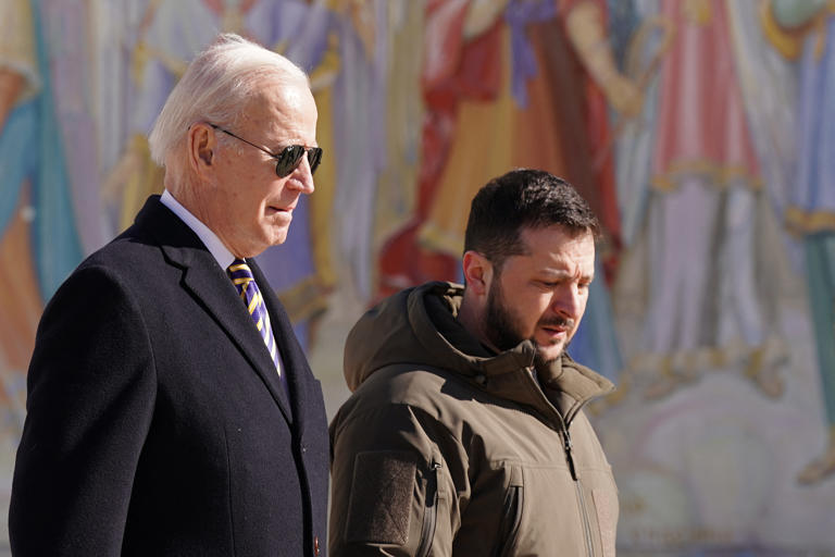 President Joe Biden walks next to Ukrainian President Volodymyr Zelensky as he arrives for a visit in Kyiv, Ukraine on February 20, 2023. Ukrainian leaders are urging the White House to lift targeting restrictions on some American weapons.