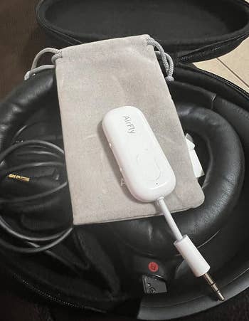 small white device packed with travel accessories