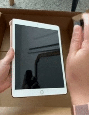 Reviewer spraying an iPad with a mister and wiping it down