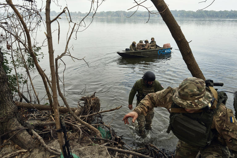 Ukrainian infantrymen soldiers travel on the Dnieper River on boats on September 14, 2023 in Kherson region, Ukraine. Russian troops are attempting to storm a key island near Kherson city, Kyiv said on Thursday.