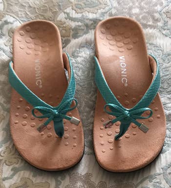 reviewer photo of the sandals in green and tan