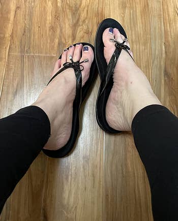 reviewer wearing the sandals in black