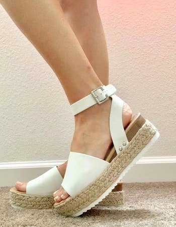 close-up of reviewer in the white sandals