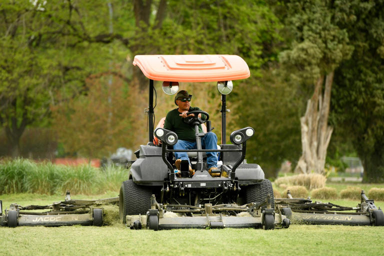 DENVER, COLORADO - MAY 26: Tim Lopez mows the lawn around Burns Garden in City Park on May 26, 2021 in Denver, Colorado. The Denver Parks Department is short staffed because of the pandemic. This means that grass wonÕt be cut as often, trash wonÕt be picked up as often and other maintenance will take longer. Parks in general are having a hard time keeping up with the new surge of people coming out of the pandemic hibernation and seeking nature and open spaces. Despite smaller staffs Scott Gilmore, Deputy Parks Manager, is proud of how beautiful the park looks and how hard his smaller staff works to maintain that beauty. (Photo by Helen H. Richardson/The Denver Post)