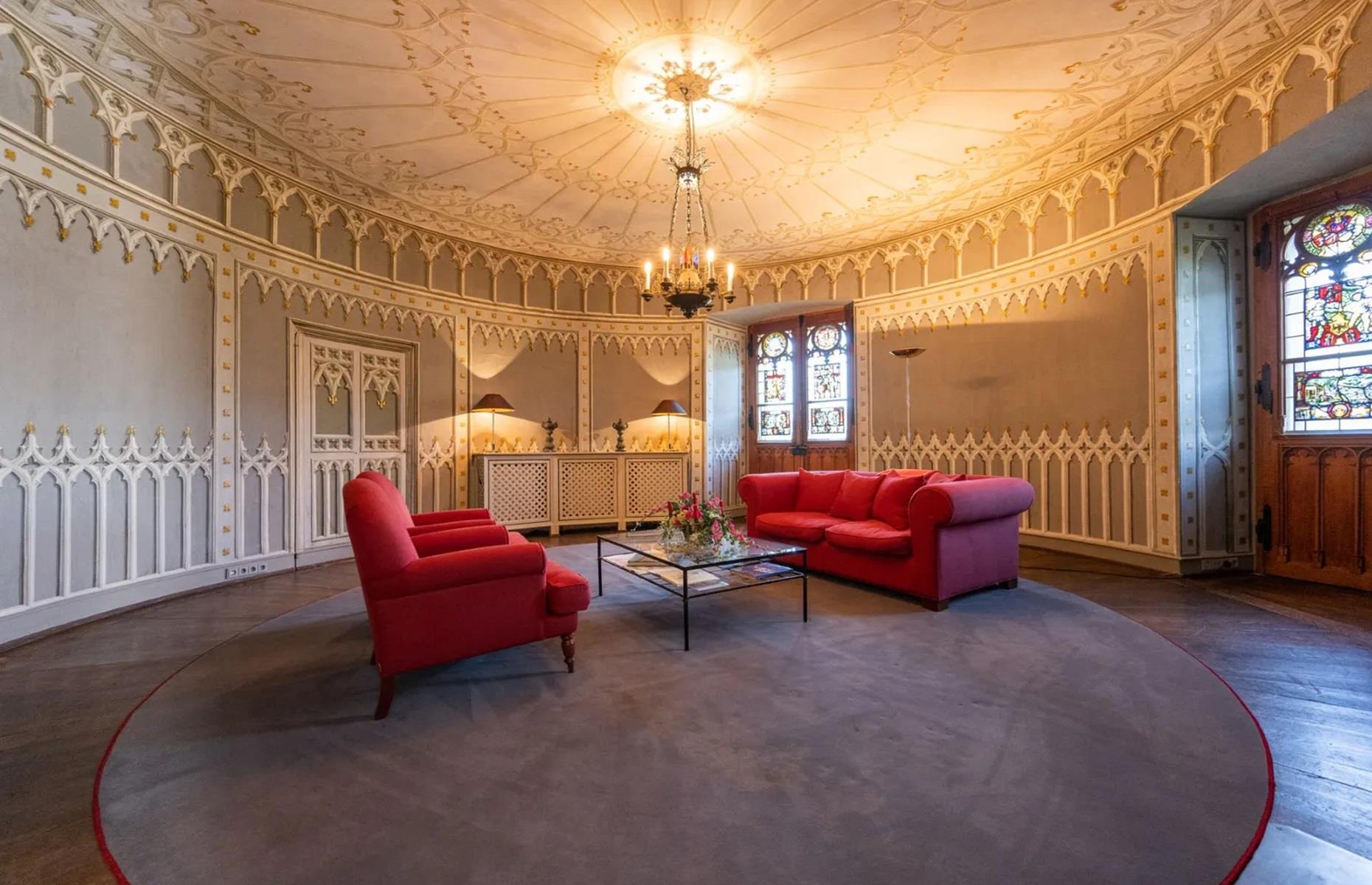 <p>There are 16 double bedrooms within the castle's hotel, as well as numerous enchanting living spaces and even a restaurant. This circular room is magnificent, with its statement ceiling and gilded details.</p>  <p>There's also a hall of mirrors, a castle parlour, a distillery room and a formal dining room that's protected by two (faux) armoured guards.</p>