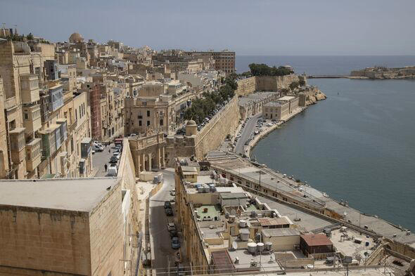 A bustling city and a vast ocean seen from a towering vantage point in Valetta, Malta