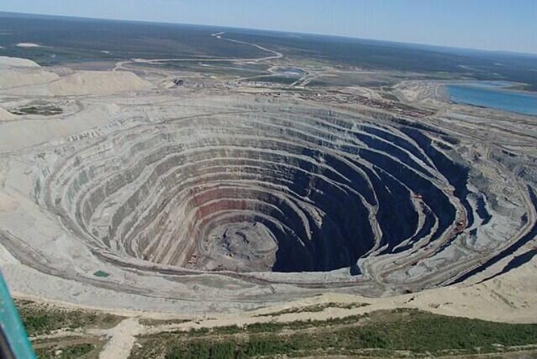 <p>A Russian diamond company by the name of Alrosa owns the Udachnaya Pipe mine found in Russia. The Udachnaya Pipe mine opened in 1955, and the last blasting took place in 2015 when Alrosa chose to switch to underground mining.</p> <p>The surface area and depth of Udachnaya Pipe mine is fantastic. Stretching about 5,249 by 6,561 feet and running 2,099 feet deep, you wouldn't want to get caught in there with no way out. Also, $80 billion worth of rough diamond has come from it.</p>