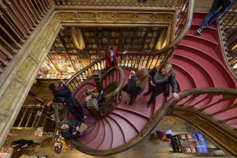 <p>Although Portugal's Livraria Lello was once just a bookstore with some ambitious architecture, it became a major international tourist attraction after Harry Potter author J.K. Rowling mentioned being inspired by the store's unique staircase. As a result, tourists pack into the store to take selfies but rarely by any actual books.</p> <p>As the Driftyland blog expressed, this has left the shop to charge admission and the crowds made it hard even to peruse the store's inventory. The famous staircase is also now in much more terrible shape than this photo suggests. Although people find it hard to blame the owners for this, Livraria Lello is nonetheless considered a tourist trap.</p>