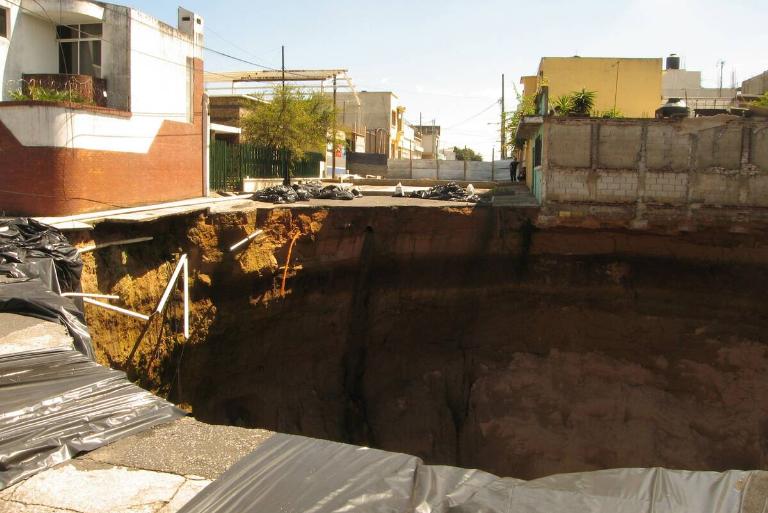 <p>On Sunday, May 30, 2010, citizens of Guatemala experienced something they could have never prepared for even if they tried. The ground collapsed and created one gigantic sinkhole. Dozens of homes fell along with it, and three people died.</p> <p>The hole was about 65-feet wide and 300-feet deep. Experts blamed floodwaters from tropical storms, but nasty old pipes could have very well been responsible for this monstrosity. It caused concern for more holes to form, thanks to the city resting on a pumice fill. Once you learn this fill is made by ash flows resulting from ancient volcanic eruptions, you probably wouldn't want to set foot near it.</p>