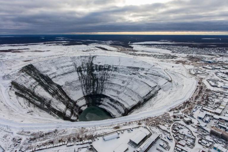 <p>The Mirny Mine is the first and one of the largest diamond mines located in the USSR. However, the diamond mine is no longer in use. It's located in Eastern Siberia and runs about 3,900 feet in diameter and 1,722 feet deep.</p> <p>Due to its massive size, it earned the nickname of "Navel of the Earth" and it's the second largest excavated hole on Earth. You can't fly over it due to reports of helicopters getting sucked in.</p>
